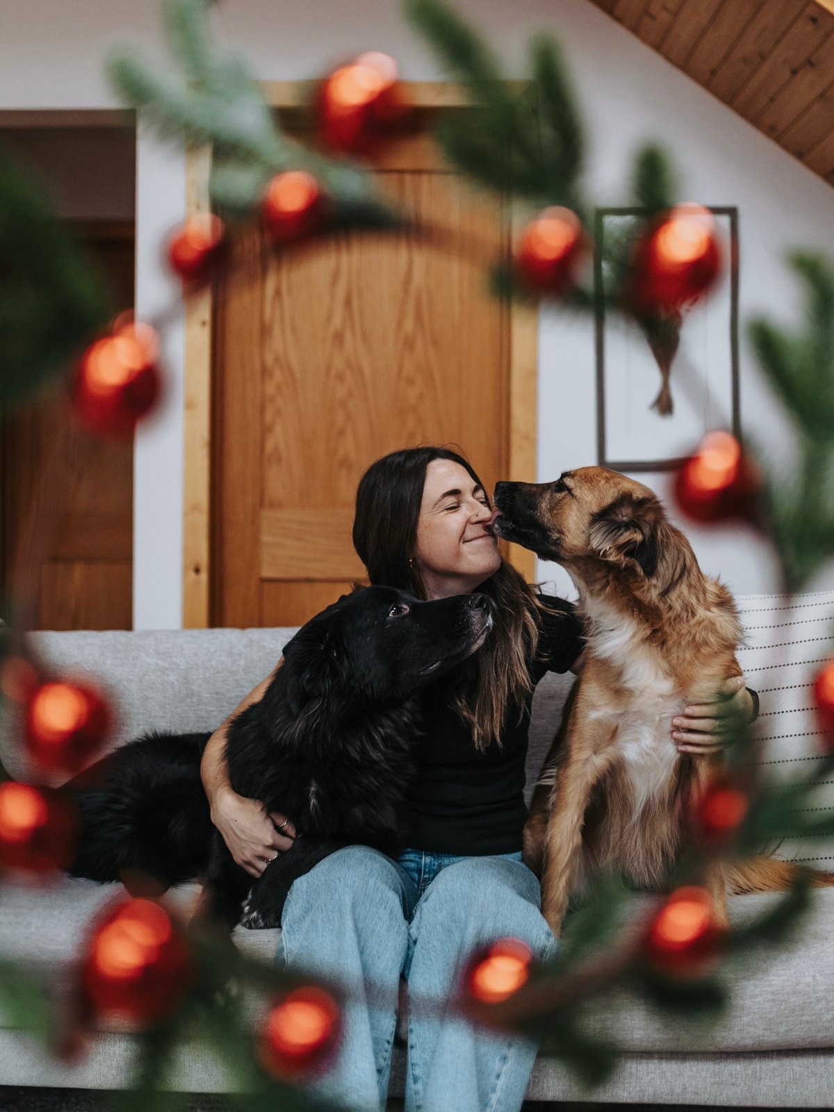 Briana MacLeod on the couch with her dogs Sadie and Angus